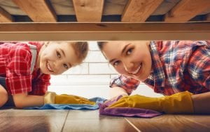 mom and child dusting around the house together