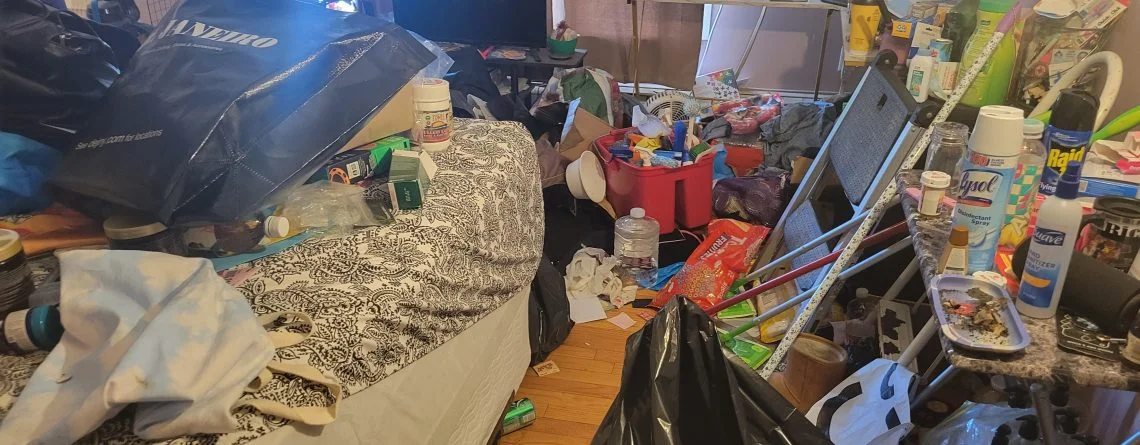 A cluttered bedroom needing a cleanup, decluttering and organizing.