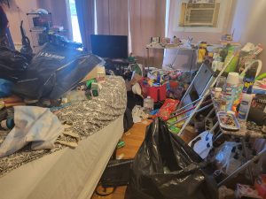 A cluttered bedroom needing a cleanup, decluttering and organizing.